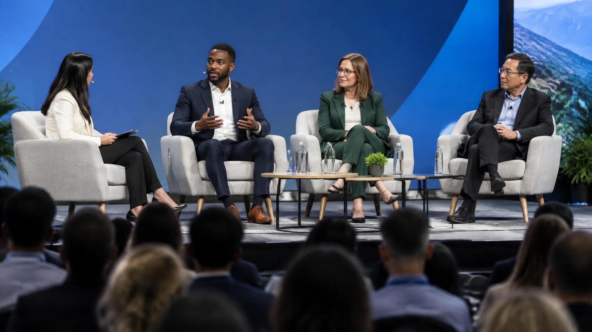 Speaker on a panel stage in front of an audience